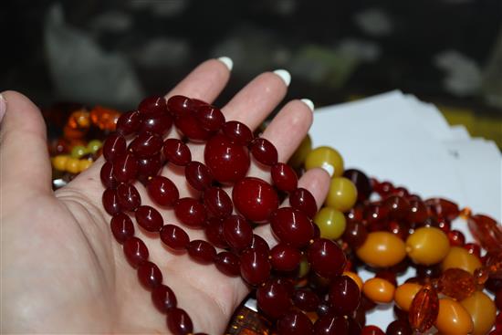 A quantity of amber and faux amber bead necklaces.